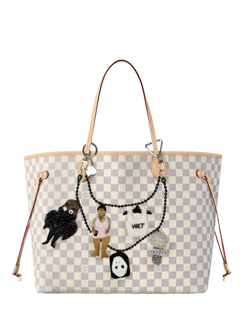 Pink Bibi doll bag charm styled on a handbag