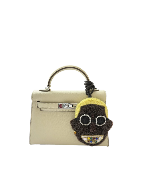 Bling Smiley bag charm styled on a handbag