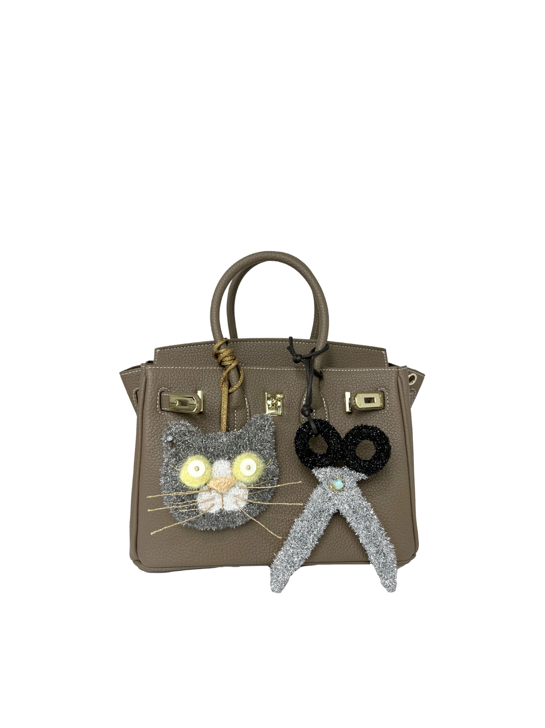Scissors bag charm styled on a handbag