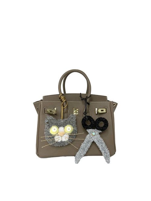 Scissors bag charm styled on a handbag